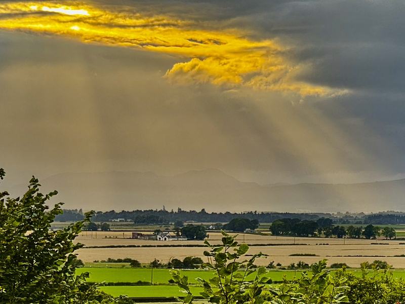 Sunlight breaking over the carse from the viewpoint