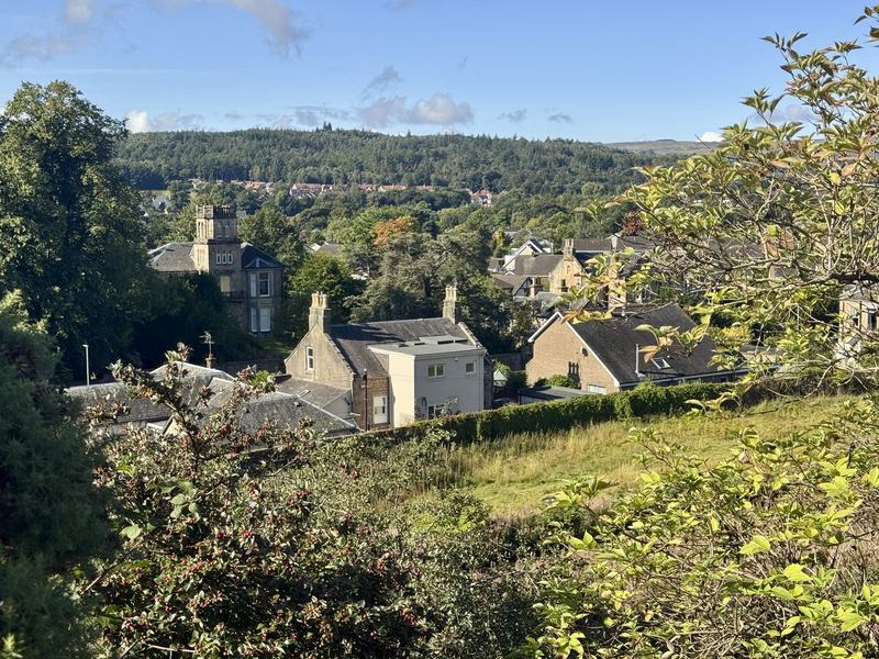 Looking down over Park Place from the southern edge of the park, with the wooded ridge of Gillies Hill beyond