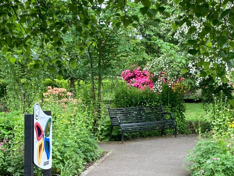 A bench beside the butterfly panel in the Peace of Mind Garden